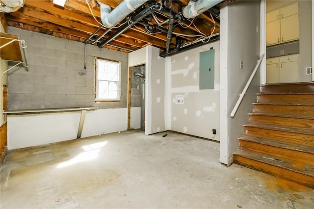 below grade area with electric panel, concrete block wall, and stairs