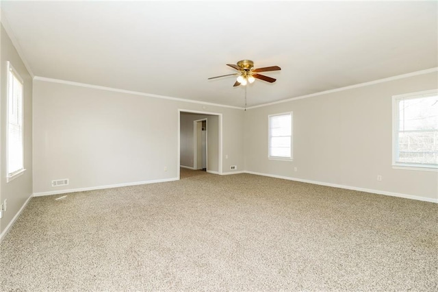 unfurnished room with visible vents, baseboards, light colored carpet, and ornamental molding