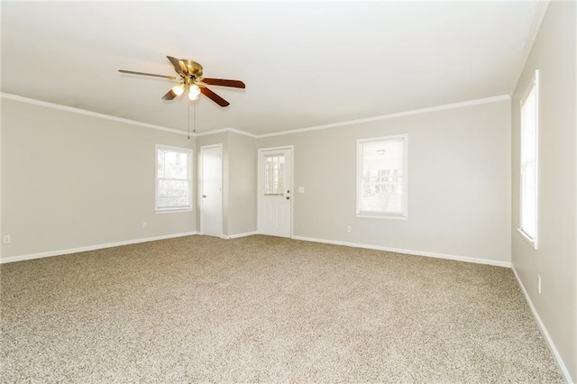 spare room with baseboards, a ceiling fan, ornamental molding, and carpet flooring