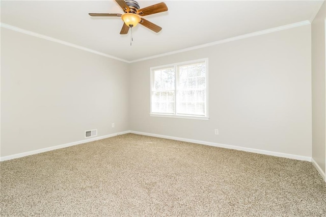 spare room featuring visible vents, ornamental molding, a ceiling fan, carpet flooring, and baseboards