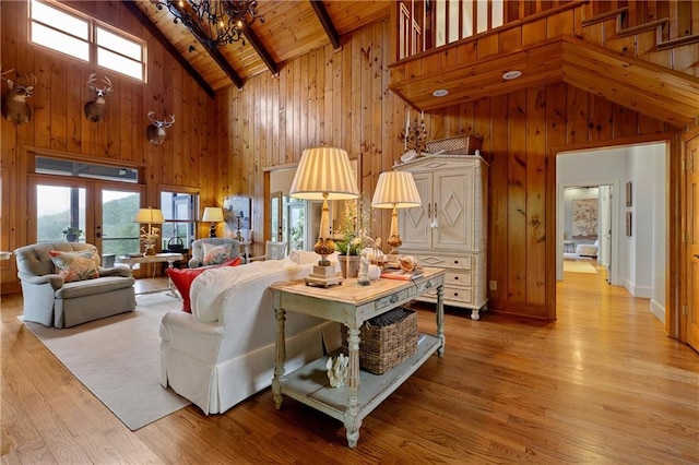 295 Goble Gap Ln, Clayton, GA 30525 - living room with high vaulted ceiling, wooden walls, a chandelier, a wooden ceiling with exposed beams, and light wood-type flooring