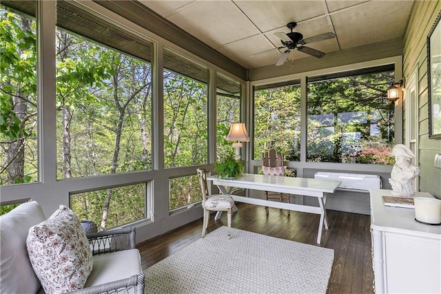 sunroom featuring ceiling fan and outdoor dining area