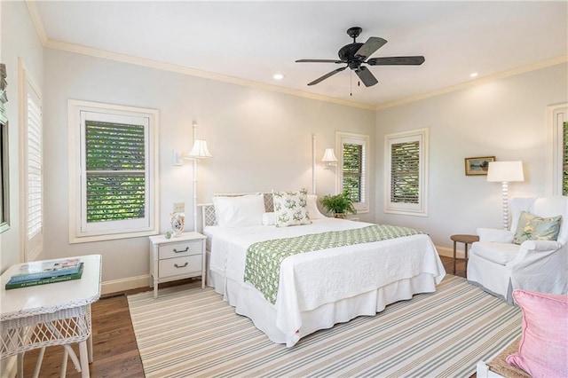 bedroom featuring wood finished floors, baseboards, crown molding, recessed lighting, and a ceiling fan