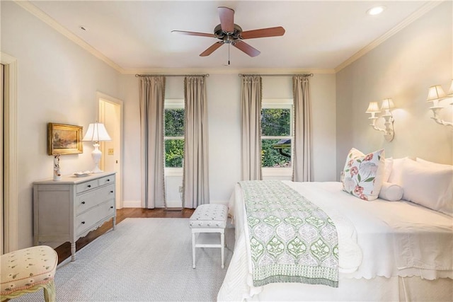 bedroom with wood finished floors, crown molding, baseboards, recessed lighting, and a ceiling fan