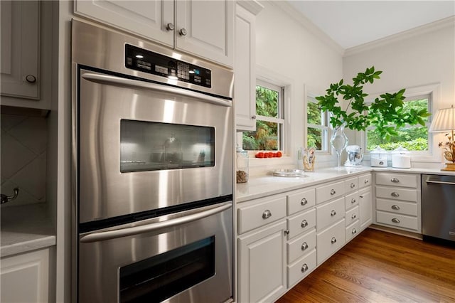 295 Goble Gap Ln, Clayton, GA 30525 - kitchen featuring appliances with stainless steel finishes, crown molding, light countertops, white cabinets, and dark wood-style floors