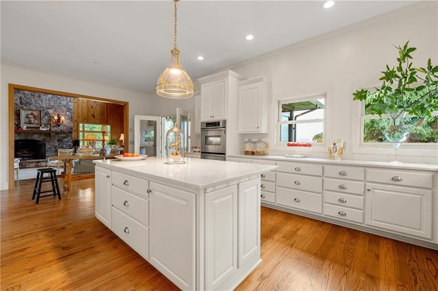 295 Goble Gap Ln, Clayton, GA 30525 - kitchen with a center island, white cabinets, light wood-type flooring, hanging light fixtures, and recessed lighting