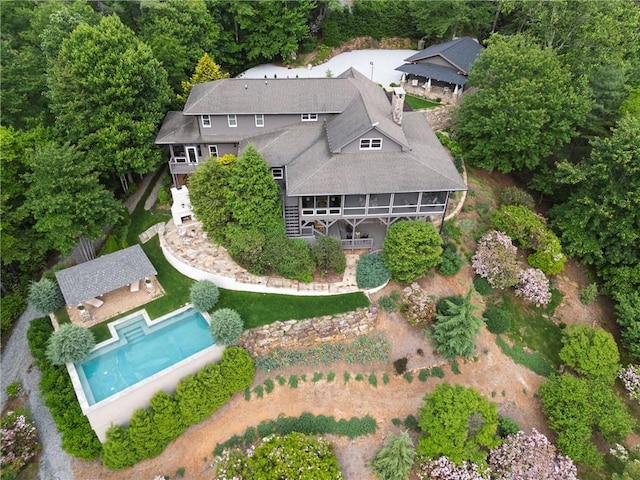aerial view of property and surrounding area with a pool area