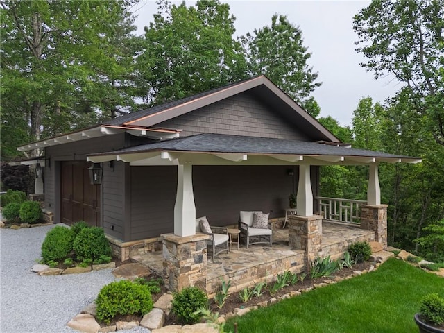 view of front of property featuring covered porch and a shingled roof