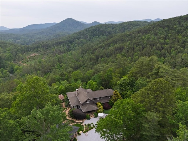 view from above of property with a heavily wooded area and mountains
