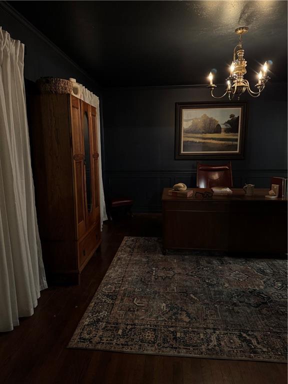 interior space featuring a notable chandelier and dark wood-type flooring