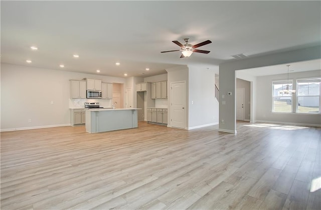 20 Fayme Ct, Newnan, GA 30263 - kitchen with stainless steel microwave, open floor plan, baseboards, and recessed lighting