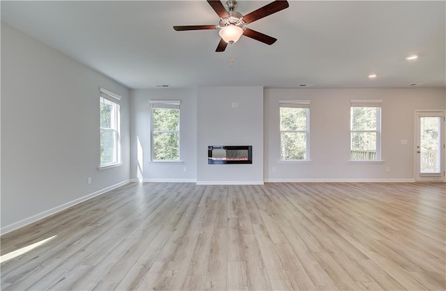 20 Fayme Ct, Newnan, GA 30263 - unfurnished living room featuring light wood-style floors, healthy amount of natural light, baseboards, and recessed lighting