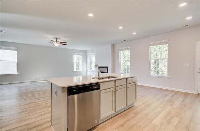 20 Fayme Ct, Newnan, GA 30263 - kitchen featuring stainless steel dishwasher, a sink, open floor plan, light countertops, and light wood-style flooring