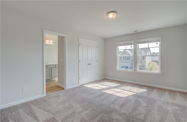 20 Fayme Ct, Newnan, GA 30263 - unfurnished bedroom featuring carpet floors, baseboards, connected bathroom, and a closet