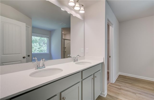 20 Fayme Ct, Newnan, GA 30263 - full bath featuring wood finished floors, double vanity, baseboards, and a shower with shower door