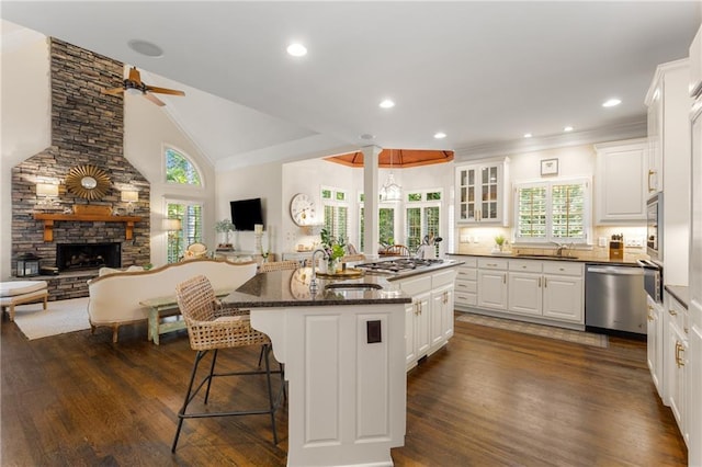 4789 Crest Park Ln, Marietta, GA 30068 - kitchen featuring appliances with stainless steel finishes, open floor plan, white cabinets, dark wood-style floors, and crown molding