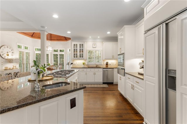 4789 Crest Park Ln, Marietta, GA 30068 - kitchen with built in appliances, a warming drawer, white cabinetry, crown molding, and dark wood-style flooring