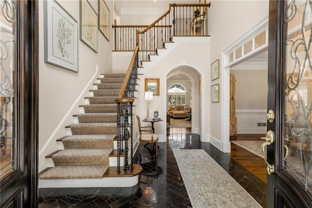 4789 Crest Park Ln, Marietta, GA 30068 - foyer entrance with arched walkways, stairs, crown molding, and a high ceiling
