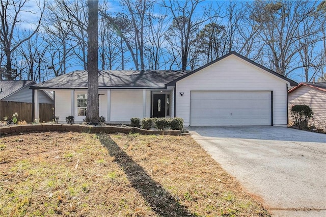 single story home featuring an attached garage, fence, and driveway