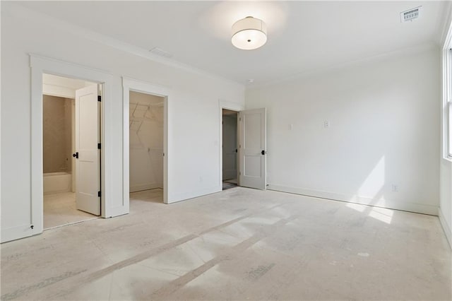 12 Night Fire Ct, Dawsonville, GA 30534 - unfurnished bedroom featuring a walk in closet, a closet, baseboards, ornamental molding, and ensuite bath
