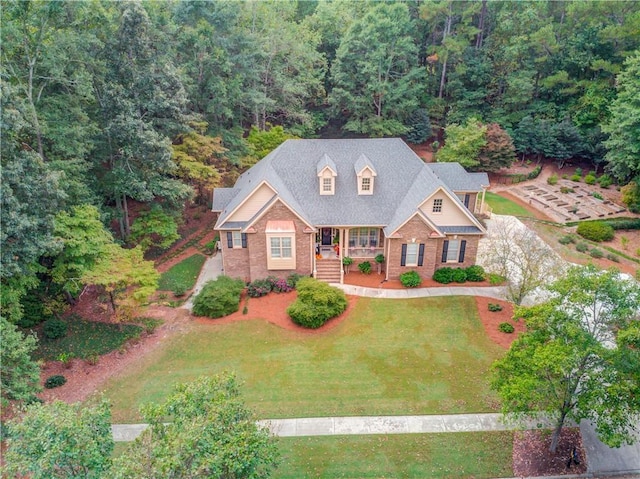 birds eye view of property with a view of trees