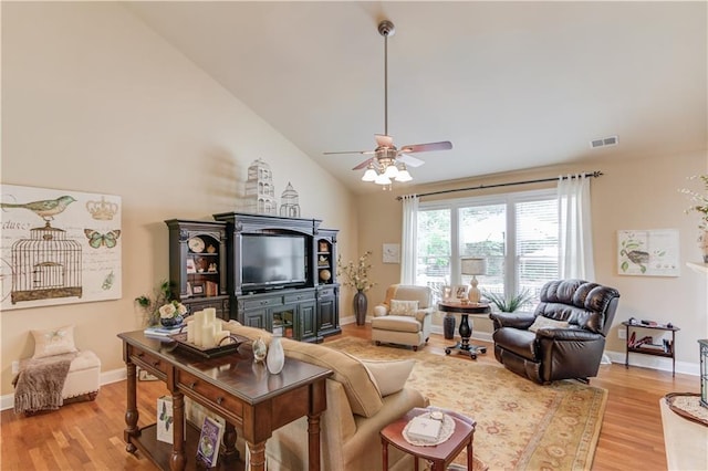 living room with baseboards, high vaulted ceiling, visible vents, and light wood-style floors