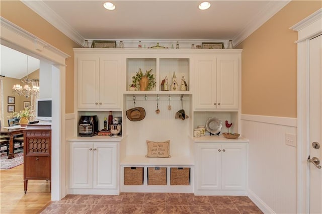 mudroom with a chandelier, ornamental molding, wainscoting, and recessed lighting