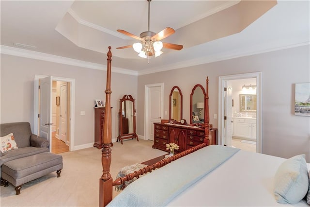 bedroom featuring baseboards, ensuite bathroom, light colored carpet, and crown molding