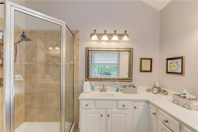 bathroom featuring a shower stall and vanity