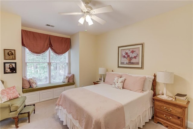 bedroom with light colored carpet, visible vents, and ceiling fan