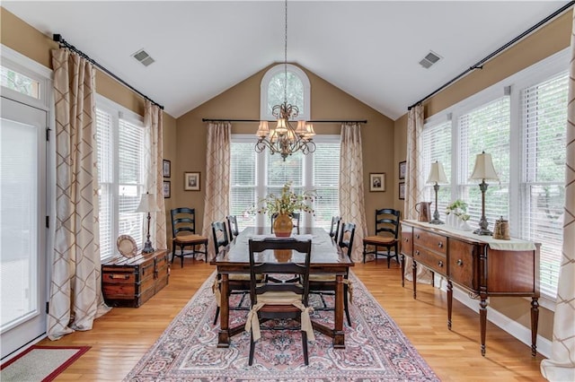 dining area featuring a chandelier, visible vents, plenty of natural light, and light wood finished floors