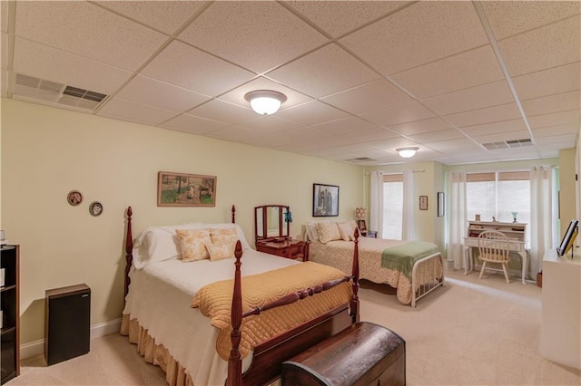 bedroom featuring light carpet, visible vents, and a paneled ceiling