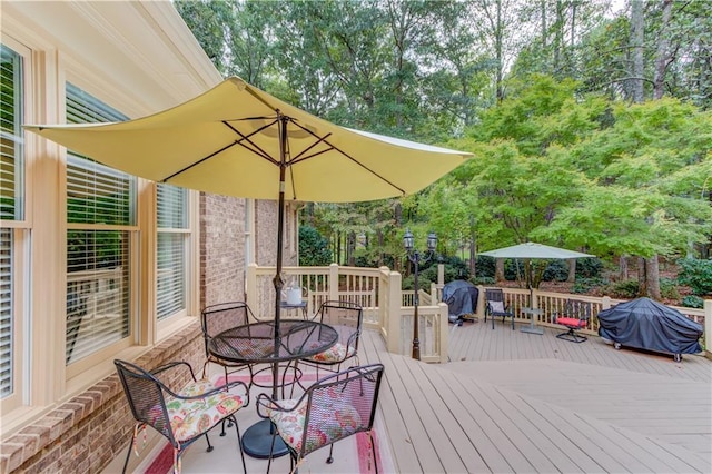 wooden terrace featuring outdoor dining space