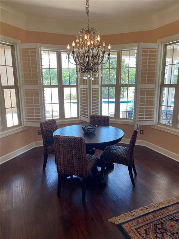 220 Pebble Beach Dr, Eufaula, AL 36027 - dining room featuring crown molding, a chandelier, baseboards, and dark wood-type flooring