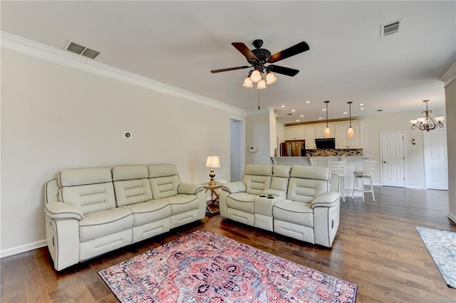 189 Azalea Chase Dr, Suwanee, GA 30024 - living area featuring a ceiling fan, ornamental molding, a chandelier, wood finished floors, and recessed lighting