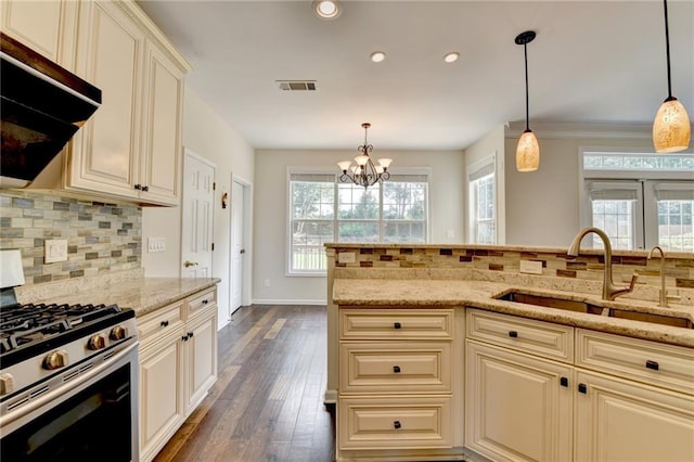 189 Azalea Chase Dr, Suwanee, GA 30024 - kitchen with stainless steel gas stove, dark wood-style flooring, tasteful backsplash, light stone counters, and recessed lighting