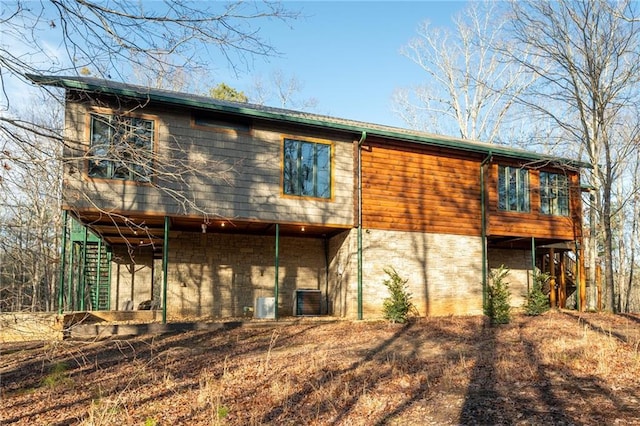 back of house featuring central AC unit