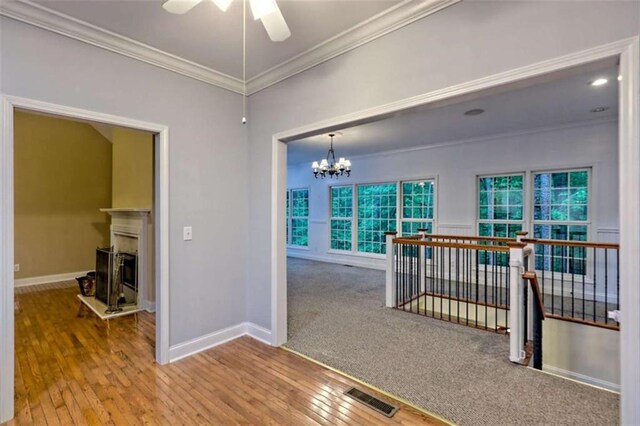 521 Crabapple Rd, Clarkesville, GA 30523 - spare room with crown molding, baseboards, a ceiling fan, a chandelier, and hardwood / wood-style floors