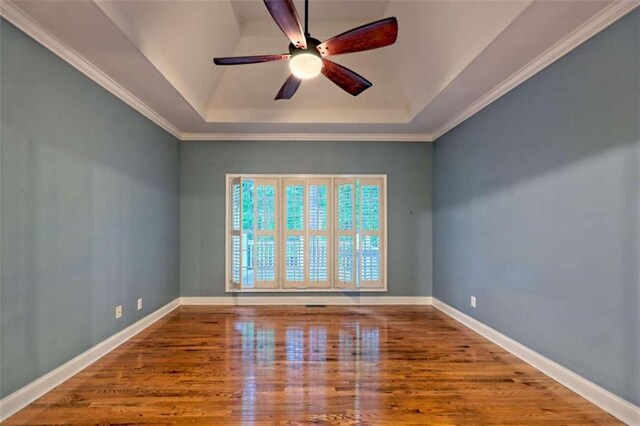 521 Crabapple Rd, Clarkesville, GA 30523 - empty room featuring a raised ceiling, a ceiling fan, wood finished floors, baseboards, and crown molding