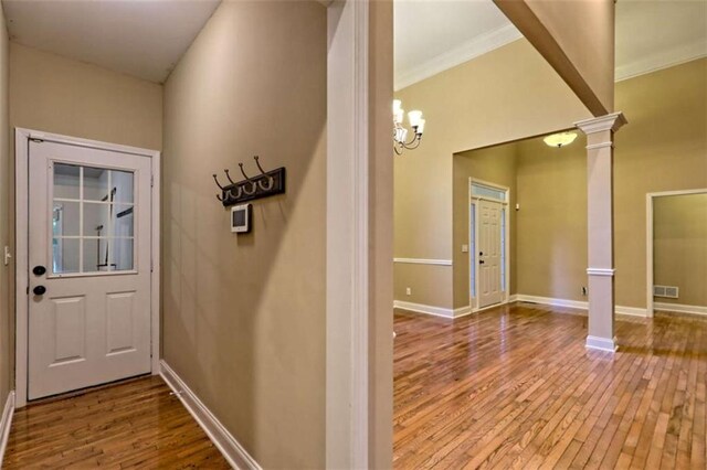 521 Crabapple Rd, Clarkesville, GA 30523 - entryway with decorative columns, wood-type flooring, ornamental molding, baseboards, and a chandelier