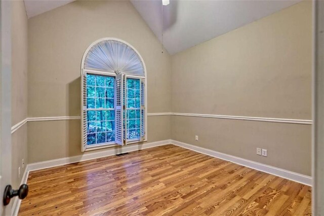 521 Crabapple Rd, Clarkesville, GA 30523 - empty room with vaulted ceiling, wood finished floors, and baseboards