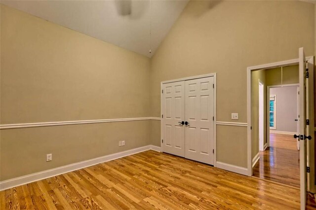 521 Crabapple Rd, Clarkesville, GA 30523 - unfurnished bedroom with wood finished floors, high vaulted ceiling, baseboards, a closet, and ceiling fan