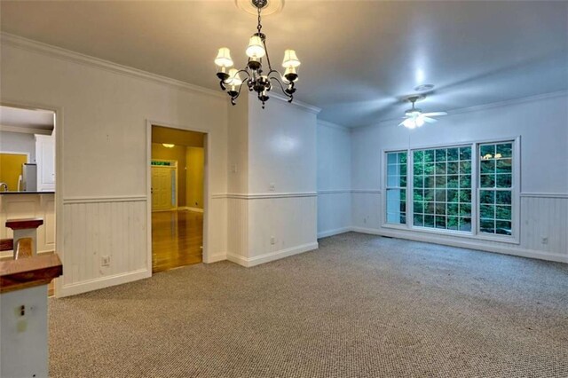 521 Crabapple Rd, Clarkesville, GA 30523 - spare room with crown molding, a chandelier, a ceiling fan, a wainscoted wall, and carpet