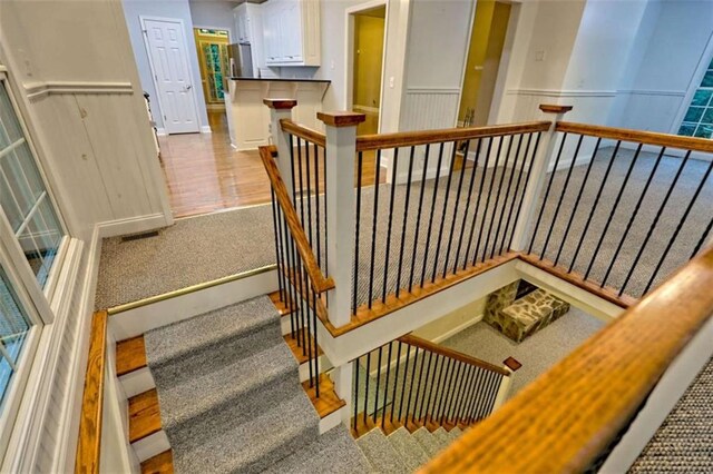 521 Crabapple Rd, Clarkesville, GA 30523 - staircase with carpet floors and a wainscoted wall
