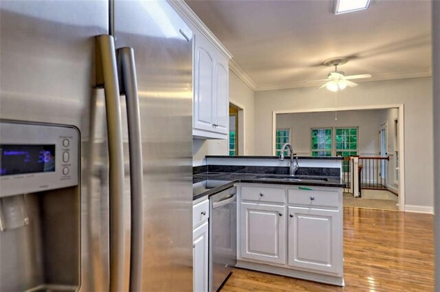 521 Crabapple Rd, Clarkesville, GA 30523 - kitchen featuring stainless steel appliances, a sink, a peninsula, white cabinets, and a ceiling fan