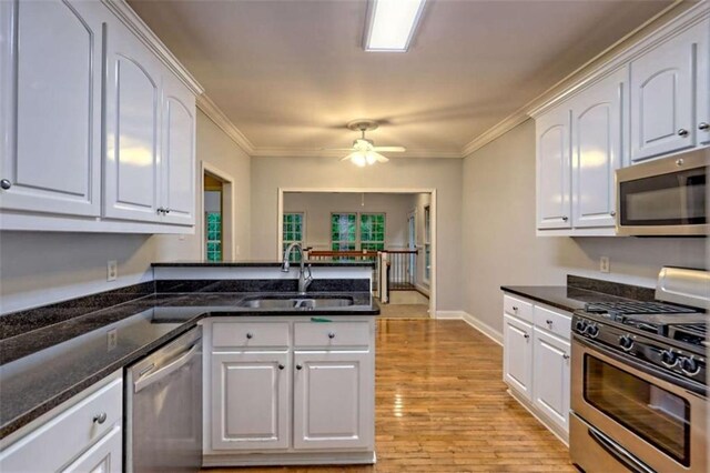521 Crabapple Rd, Clarkesville, GA 30523 - kitchen with appliances with stainless steel finishes, a sink, white cabinets, and ornamental molding