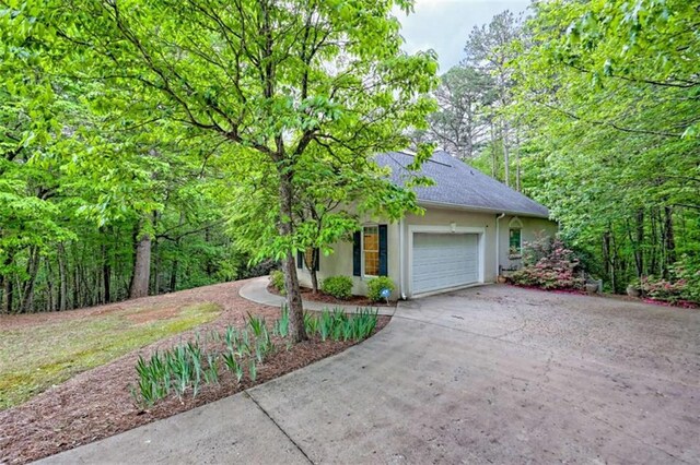 521 Crabapple Rd, Clarkesville, GA 30523 - view of front facade with stucco siding, driveway, a garage, and roof with shingles
