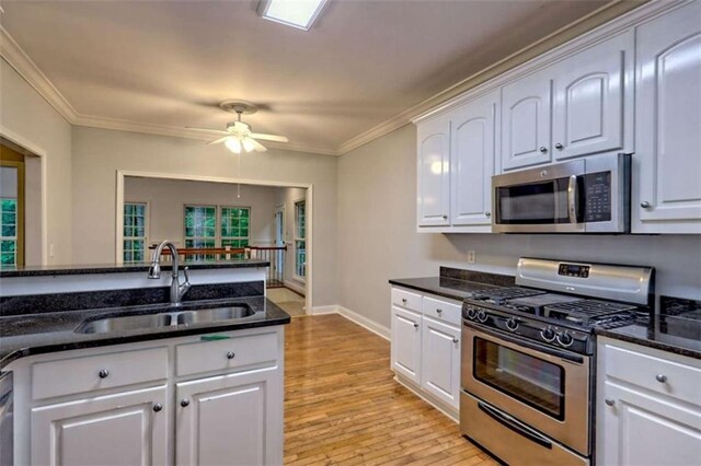 521 Crabapple Rd, Clarkesville, GA 30523 - kitchen featuring appliances with stainless steel finishes, a sink, white cabinetry, ceiling fan, and ornamental molding