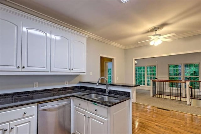 521 Crabapple Rd, Clarkesville, GA 30523 - kitchen with stainless steel dishwasher, a sink, a peninsula, a ceiling fan, and white cabinets