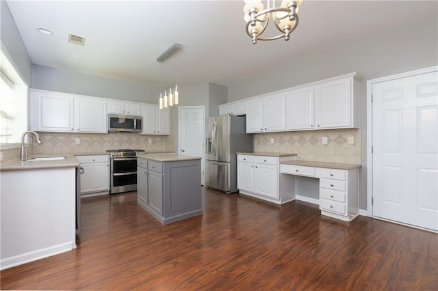 kitchen with white cabinetry, appliances with stainless steel finishes, dark wood-type flooring, and a sink